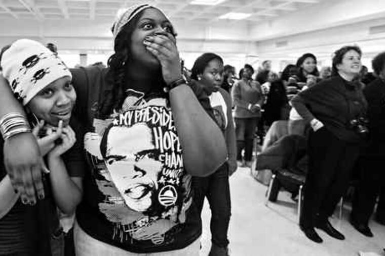 At Cheyney University, Sharita Porterfield (left) and Ibijoke Akinbowale, both from Washington, watch with other students, faculty and staff members as President Obama takes the oath of office.