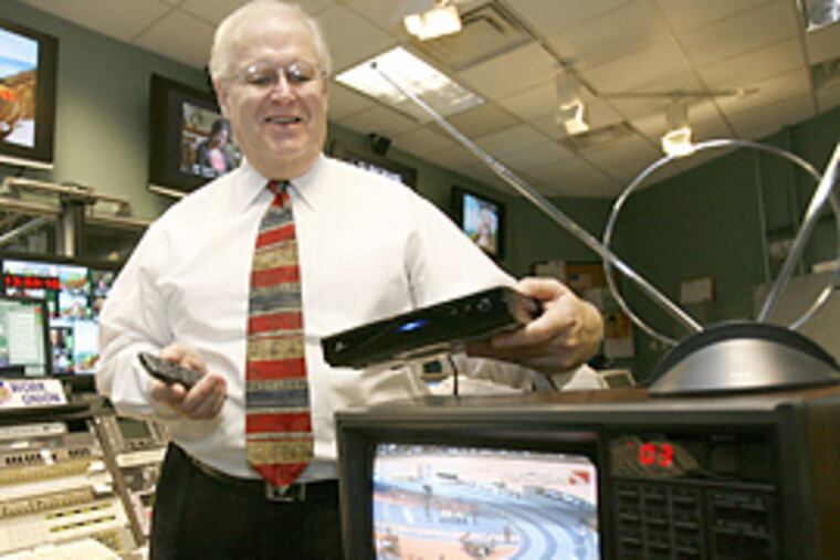 William Weber, chief technology officer at WHYY, demonstrates how a digital converter box can be attached to convert old televisions in the WHYY control room. (Charles Fox/Inquirer)