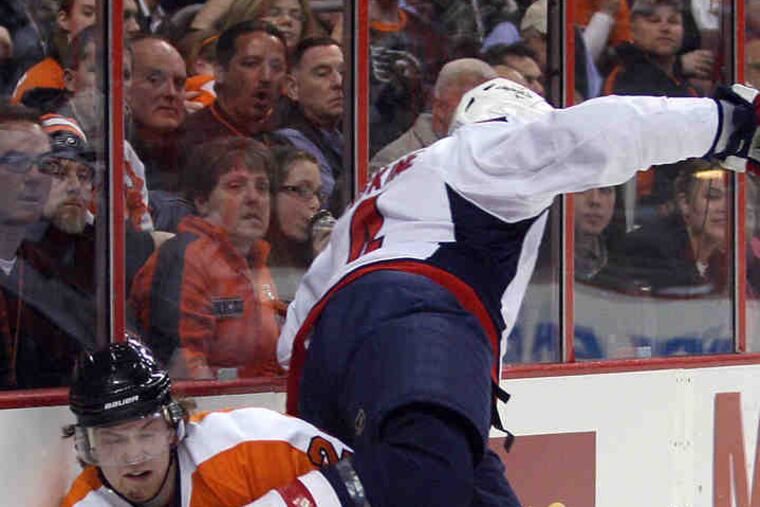 Flyers' Claude Giroux, Capitals' John Erskine meet along the boards in second period.