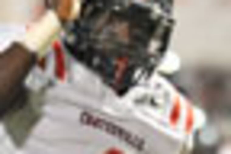 Coatesville running back Daquan Worley leaps over Spring Ford defensive back Ben Schein enroute to a 17-yard gain in the 4th quarter. Coatesville beat Spring Ford 59-28 to capture the District 1 Class AAAA title Nov. 30, 2012. ( CLEM MURRAY / Staff Photographer )