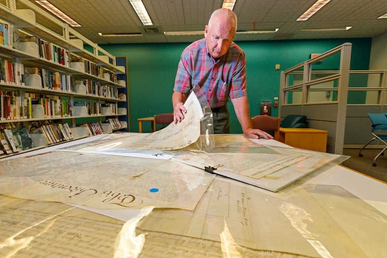 Jim Reis looks through his collection of historical deeds.