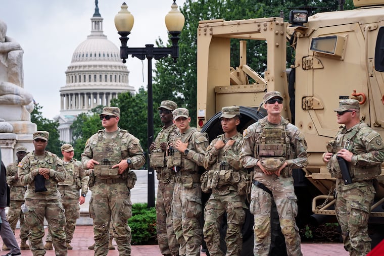Protesters, police, and National Guard members congregate at the entrance to Union Station in Washington, where Defense Secretary Pete Hegseth and Vice President JD Vance visited on Wednesday.