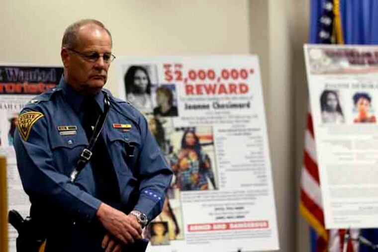 Col. Rick Fuentes, superintendent of the New Jersey State Police, stands next to posters during a news conference giving updates on the search of Joanne Chesimard, a fugitive for more than 30 years, Thursday, May 2, 2013, in Newark, N.J. The reward for the capture and return of convicted murderer Chesimard, one of New Jersey’s most notorious fugitives, was doubled to $2 million Thursday on the 40th anniversary of the violent confrontation that led to the slaying of a New Jersey state trooper. The FBI also announced it has made Chesimard, now living in Cuba as Assata Shakur, the first woman on its list of most wanted terrorists. (AP Photo/Julio Cortez)