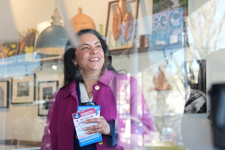 Analilia Mejia, the Democratic candidate running for New Jersey's 11th congressional district, talks to people at coffee shop in Morristown, N.J., Tuesday, March 24, 2026. (AP Photo/Seth Wenig)