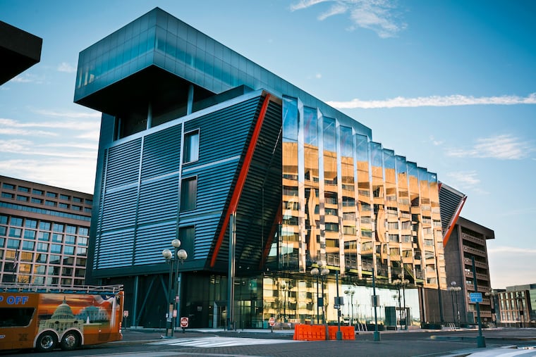 From the outside, the just-opened International Spy Museum in Washington reads as an inverted rectangular pyramid, topped by a cantilevered box, with industrial-looking supports anchored into the ground. The exterior metal skin, which the architects call "the veil," is fitted with lights that define its shape at night.
