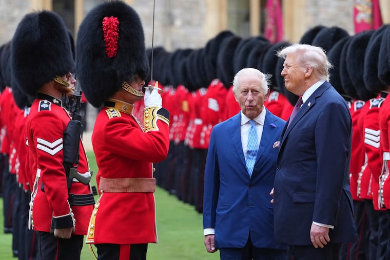 U.S. President Donald Trump and Britain's King Charles III review the Guard of Honour after the arrival at Windsor Castle in Windsor, England, on Sept. 17, 2025.