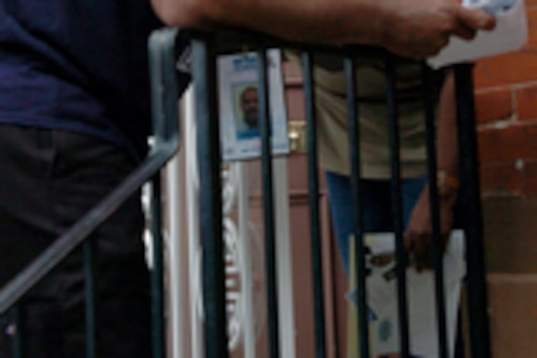 Chaka Fattah worker Larry Mays canvasses in North Philly yesterday.