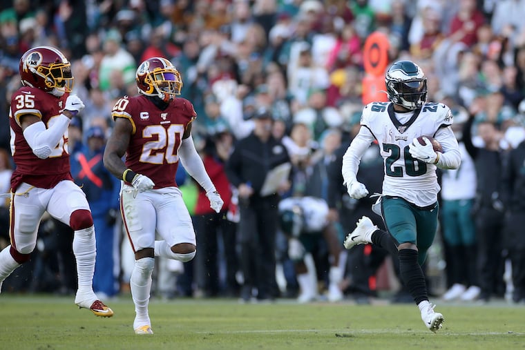 Eagles running back Miles Sanders burns downfield on a 56-yard run that set up a fourth-quarter touchdown at Washington on Sunday.