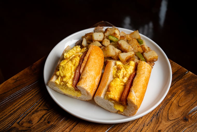 Zack's bacon egg & cheese at Hannah K in Philadelphia. It features thick-cut bacon, scrambled eggs, Cooper Sharp, and garlic aioli on a baguette