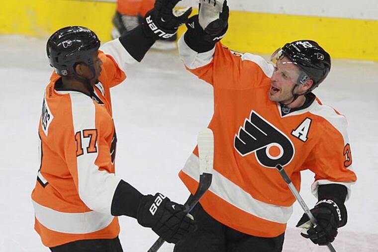 Wayne Simmonds is congratulated by teammate Mark Streit. (Charles Fox/Staff Photographer)