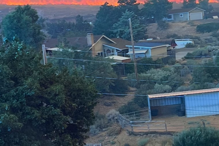 This image provided by Cari Kieffer shows part of the Hawk fire in Reno, Nev. Kieffer says she and her family evacuated before their house burned down.