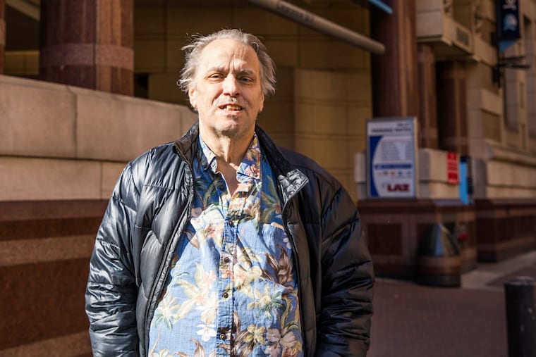 Robert L. Johnson, Jr., stands in front of Thomas Jefferson Hospital, where he received a new liver.
