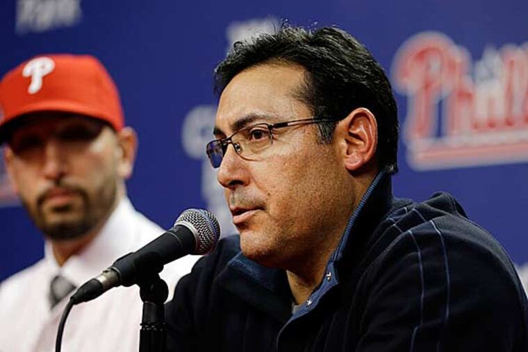 Phillies GM Ruben Amaro Jr., speaks as new relief pitcher Mike Adams listens during a baseball news conference Thursday, Dec. 20, 2012, in Philadelphia. (Matt Rourke/AP)