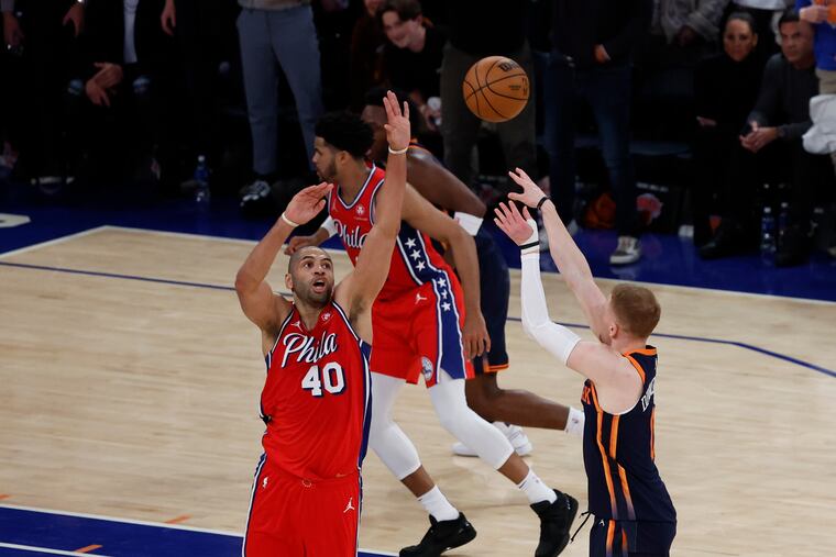 Donte DiVincenzo of the Knicks hits the go-ahead three-pointer past the Sixers' Nic Batum with 13 seconds left in Game 2.