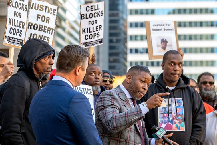Michael Jones (far right), the younger brother of Robert Jones, is joined by attorneys Shaka Johnson (center) and Kevin O’Brien (left) during a rally outside City Hall Monday. Jones’ relatives say they have received no updates from the city in the six weeks since the unarmed man was shot and killed by an off-duty Philadelphia homicide detective.