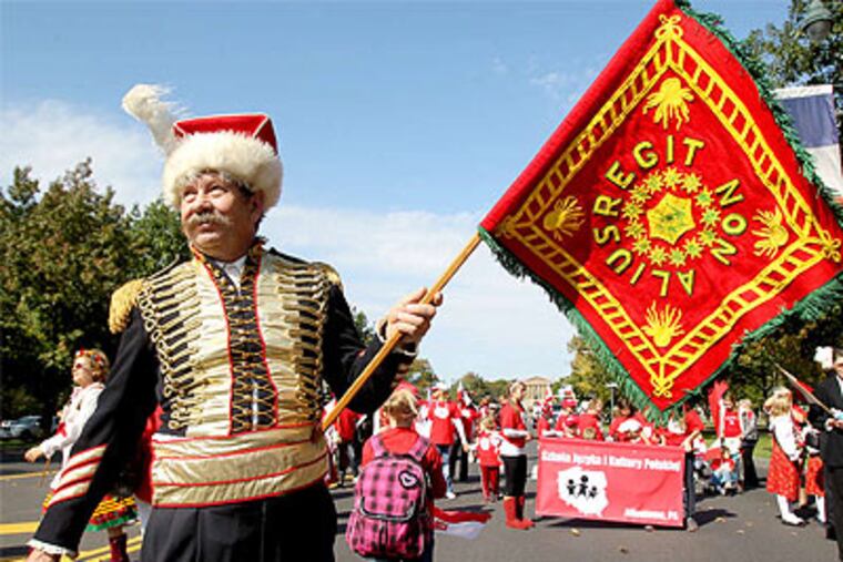 Joseph Janik of the Polish National Alliance Council 171 holds a replica of the banner carried by Gen. Casimir Pulaski. (Charles Fox / Staff Photographer)
