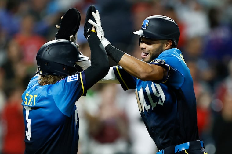Justin Crawford (right) celebrates his eighth inning two-run homer with teammate Bryson Stott on Friday.