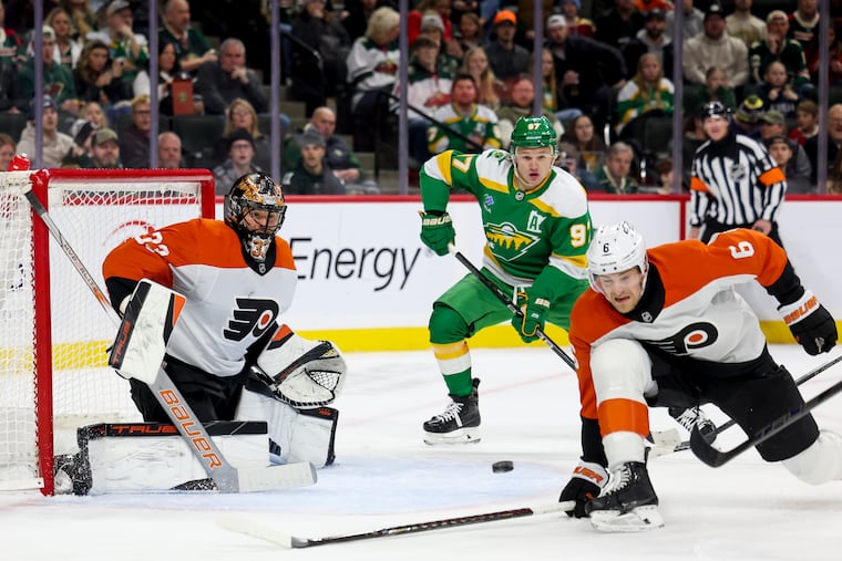 Flyers goaltender Samuel Ersson (33) prepares to save the puck while Flyers defenseman Travis Sanheim (6) dives to block against the Minnesota Wild on Dec. 14.