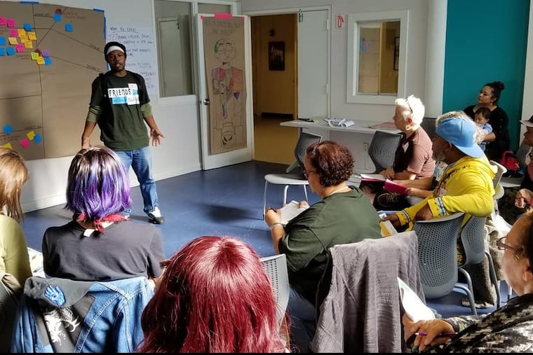 Friends of the Library member Josh Mitchell explains proposed improvements to local branches at a Nov. 3 meeting in North Philadelphia.