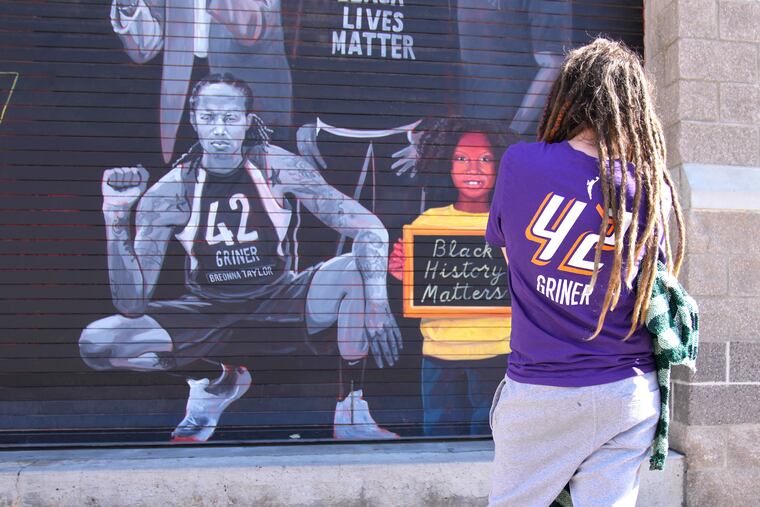 Carly Givens showing support for Brittney Griner by visiting a mural in Phoenix featuring the WNBA star on the day of Griner's release from a Russian prison earlier this month.