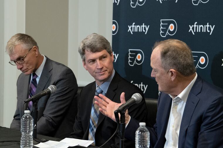 Flyers GM Chuck Fletcher (center) and club chairman Dave Scott (right) are trying to improve the team's future schedules. In this fie photo, former club president Paul Holmgren is to the left.
