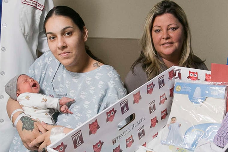 Janessa Hernandez and 3-day-old son Noah LeBròn, with nursing director Jennifer Rodriguez, right, next to a box Temple hopes will save infant lives.