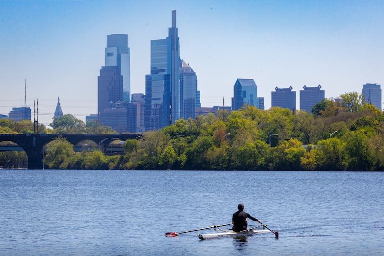 A sculler rows on the Schuylkill during last month's hot spell. Here comes a repeat.