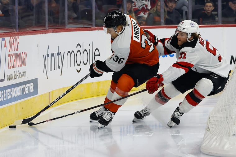 Flyers defenseman Emil Andrae skates after the puck against New Jersey center Dawson Mercer during a preseason game on Sept. 30.