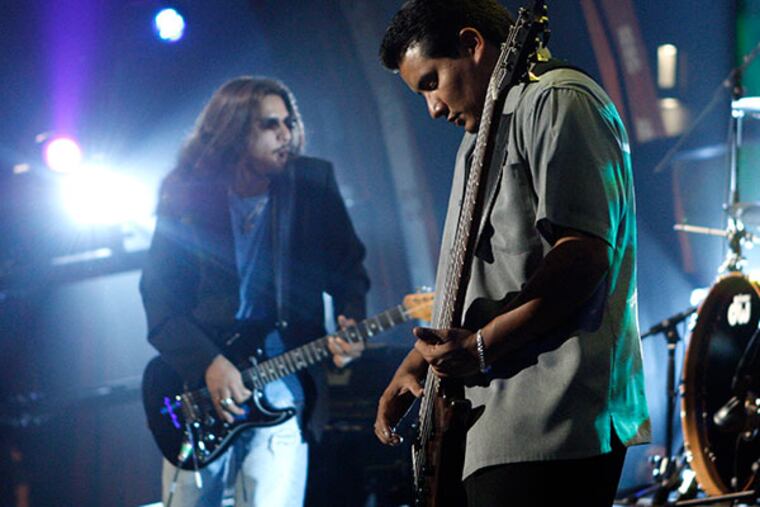 Henry Garza, right, and Jojo Garza, of the music group Los Lonely Boys, perform with the band as part of Nissan Live Sets on Yahoo! Music in Los Angeles on Thursday, July 24, 2008. (AP Photo/Matt Sayles)