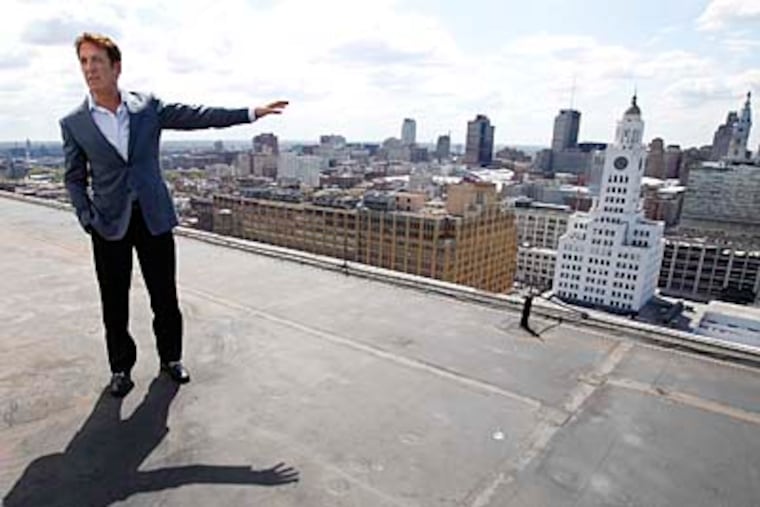Developer Bart Blatstein, atop the Tower Place at Broad and Spring Garden Streets, gestures toward the former Inquirer building, which he proposes to turn into a casino-hotel complex. DAVID MAIALETTI / Staff Photographer