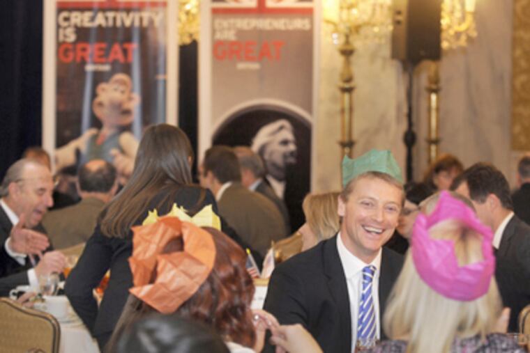 Wearing the paper crown from his "Christmas cracker," Toby Wallace of Aberdeen Asset Management enjoys the gathering at the Ritz-Carlton. Christmas crackers are part of the holiday celebrations in Britain. (Tom Gralish / Staff Photographer)
