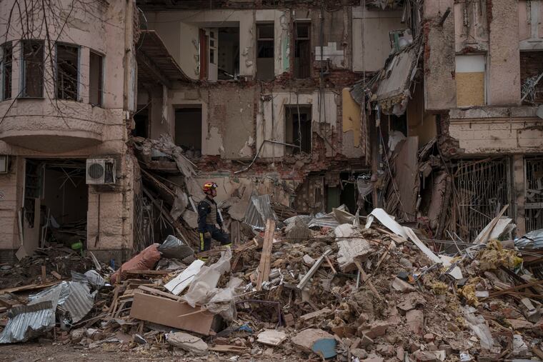 Firefighters clear the debris and search for bodies under the rubble of a building hit weeks ago by a Russian attack after receiving reports of a smell emerging from the area, in Kharkiv, Ukraine.