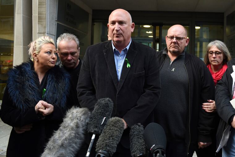 The family of Harry Dunn, from left, mother Charlotte Charles, stepfather Bruce Charles, family spokesman Radd Seiger, father Tim Dunn and stepmother Tracey Dunn speak to the media outside the Ministry Of Justice in London.