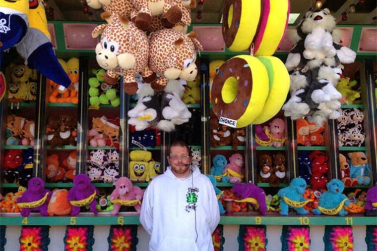 The secret to drawing a carnival-game crowd? "Friendliness," says barker Jonny McIlroi, of Ballycastle, N. Ireland, working in Wildwood. (AUBREY WHELAN / Staff)