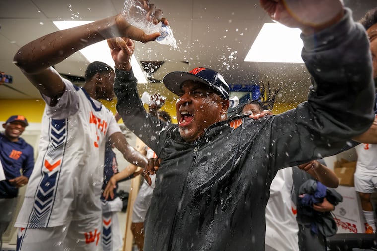 West Philadelphia boys' basketball players spray water on head coach Adrian Burke after their 68-47 win over Dobbins Tech in a Public League boys' basketball semifinal on Tuesday at La Salle's John Glaser Arena.