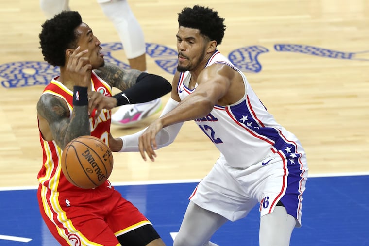 Tobias Harris, right, of the SIxers stripped the ball away from John Collins of the Hawks during a game Wednesday at the Wells Fargo Center.