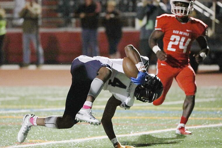 St. Augustine's Nasir Hill tries to maintain his balance while scoring a touchdown on Friday against Rancocas Valley.