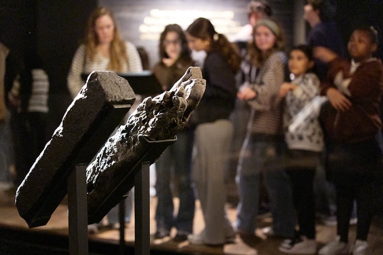 School children visit the National Museum of African American History and Culture's Middle Passage exhibit, behind a wooden timber, the artifact at right, from the slave ship, the São José-Paquete de Africa, Friday, March 6, 2026, in Washington.