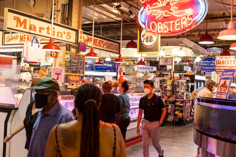 People walk and shop through Reading Terminal Market in Center City on Aug., 11, 2021.