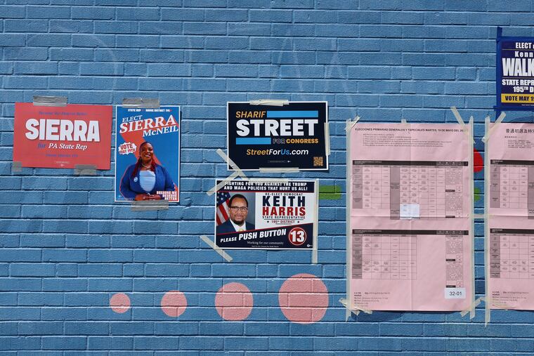 Campaign posters decorate an outside wall at the polling place at William D. Kelley School on Tuesday. Pennsylvania voters are picking their candidates for the 2026 midterm election in November.