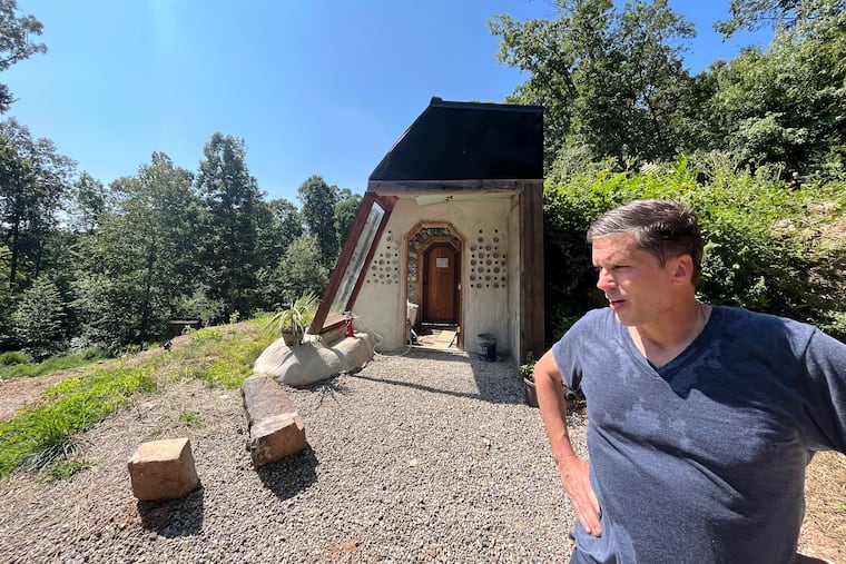 Will Vogler, an Ardmore resident, stands by a doorway to his unfinished Earthship in Tamaqua, Schuylkill County.