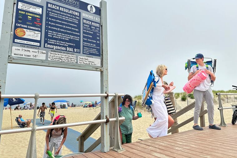 Beachgoers walk onto the boardwalk at Ocean Grove, N.J., on Sunday, May 26, 2024. Beachgoers were out on the sand of one New Jersey shore community on a Sunday morning before Memorial Day for the first time in generations amid a battle over a Christian religious group’s Sunday morning beach closures.