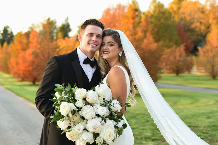 Megan O'Donnell and her groom Louis Capelli amongst the autumn colored trees at their mini-reception at Karamoor Estate Vineyard & Winery in Fort Washington, PA. 11/13/2020 Photo by Rebecca Barger Photography.