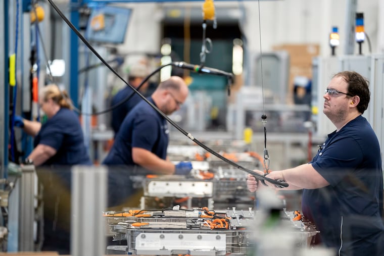 Employees work at the BMW Spartanburg plant in Greer, S.C., in 2022. A shift toward a service-based economy and away from manufacturing is one reason there are fewer men in the workforce, say economists.