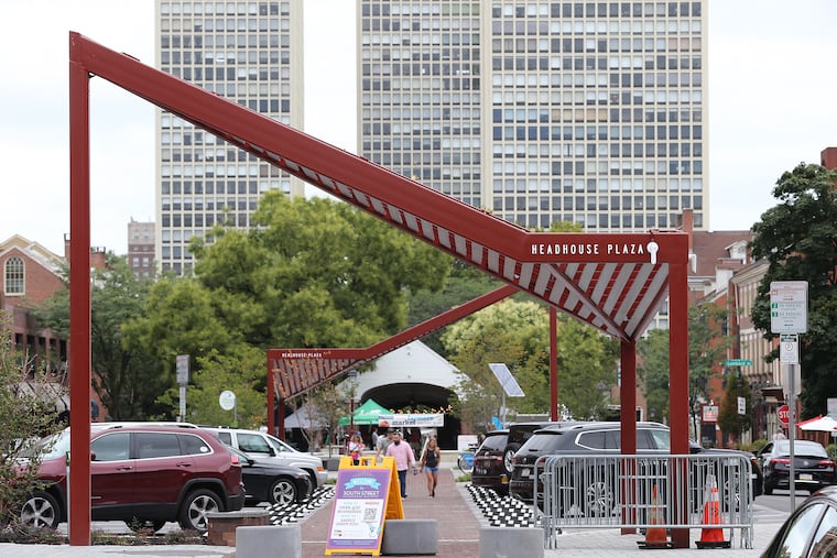 Pedestrians walk through the new Headhouse Plaza, which connects South Street to the shambles structure where a popular farmers market is held on Sundays. The angles of the canopies reference the pitch of the shambles roof.