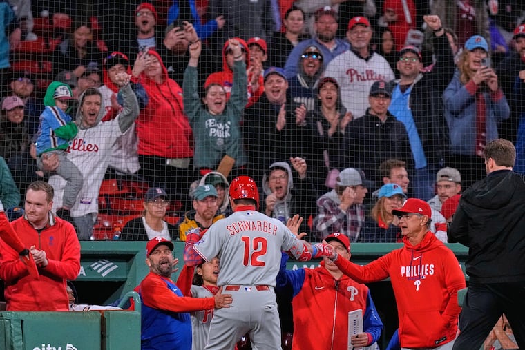 Kyle Schwarber (12) is congratulated after his two-run home run during the eighth inning.