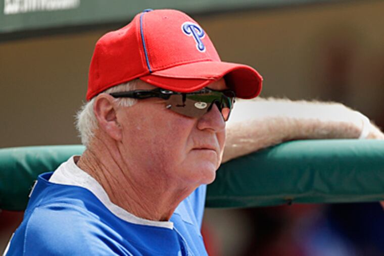 Phillies manager Charlie Manuel looks on during the first inning of a spring training game. (AP Photo/Charlie Riedel)
