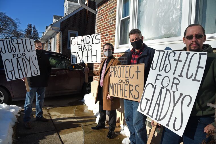 The family of Gladys S. Rodriguez Cordova gathers outside her home in Fox Chase on Feb. 4, 2021, the day after her funeral and two weeks after she was shot by her ex-husband in front of the house. Together at right are her sons Emmanuel D. Nieves, 27 (from left); Julio Moran, Jr., 36; and Anthony Moran, 33. Their sister, Gladys A. Nieves, 26, returned to California after the funeral. Their uncle Joel Nieves, 45, is at left.