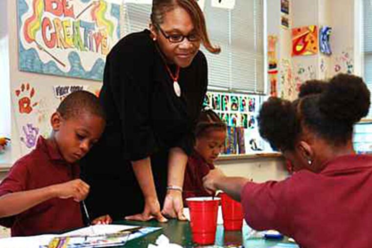 Principal Annette Anderson stands alongside kindergartners Mekhi Graves (left) and Sonye Williams (right) at Widener partnership Charter School..
