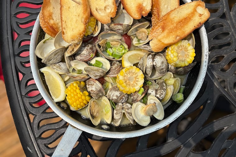 The clambake at Polly's Dock and Clamhouse comes with 50 locally harvested littlenecks in a saute pan with corn and potatoes and garlic bread to soak up the clammy wine broth